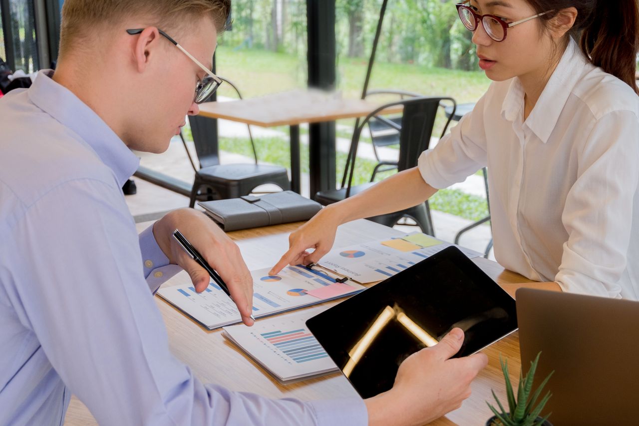 Team collaboration over financial documents in a modern office setting.